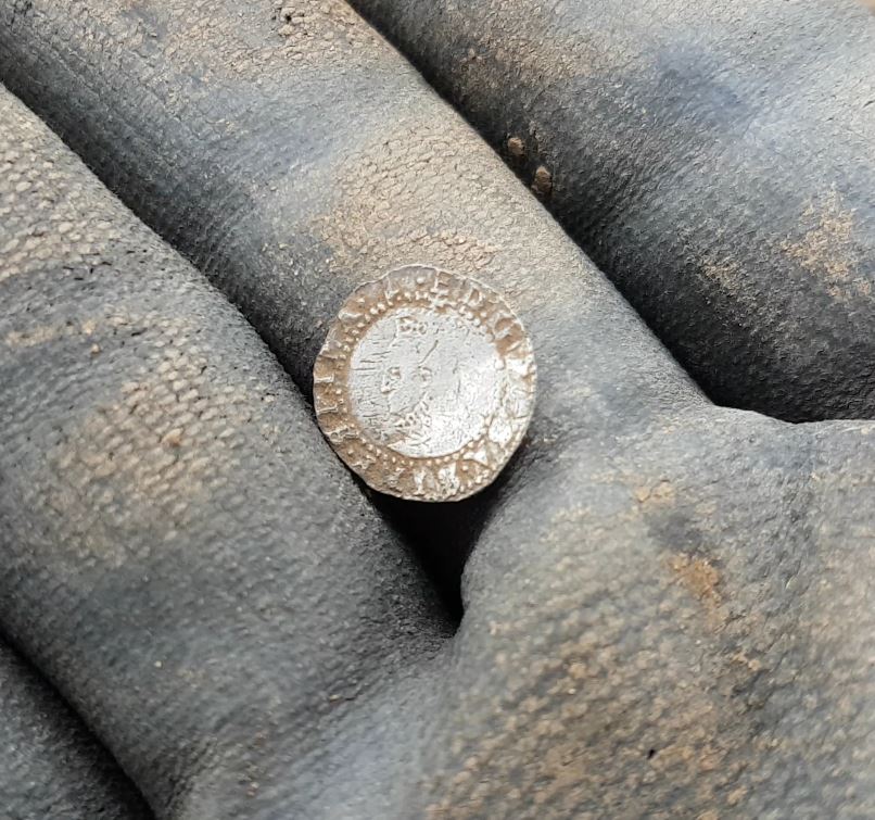 Queen Elizabeth 1st coin in a hand