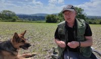 German shepherd sitting next to his owner