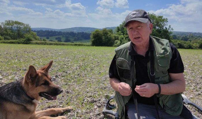 German shepherd sitting next to his owner