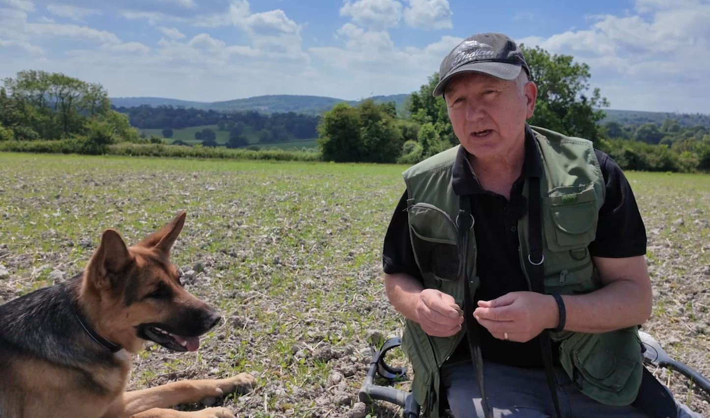 German shepherd sitting next to his owner